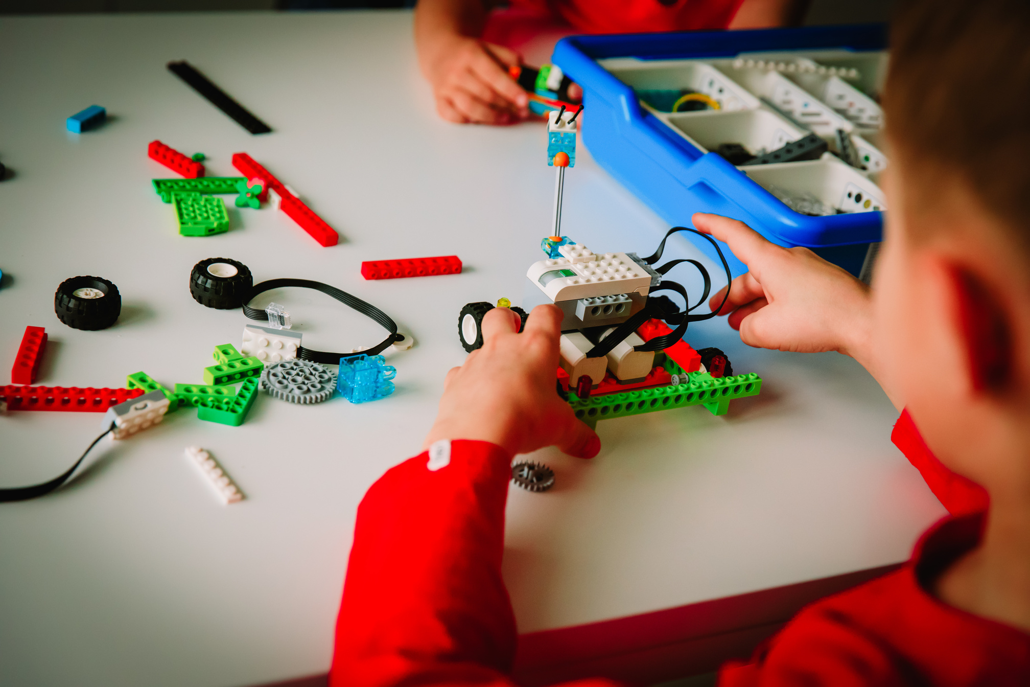 kids building robot at robotic technology school lesson