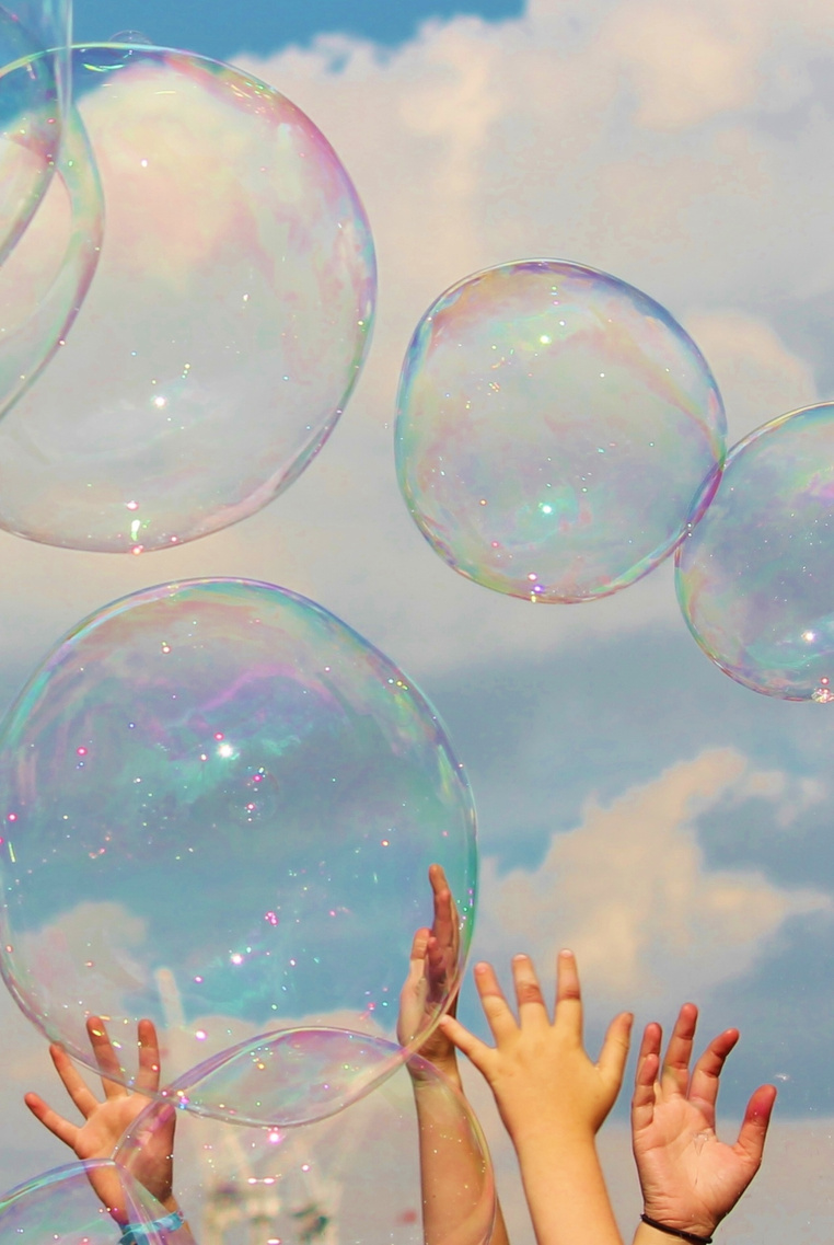 children hands reach for bubble